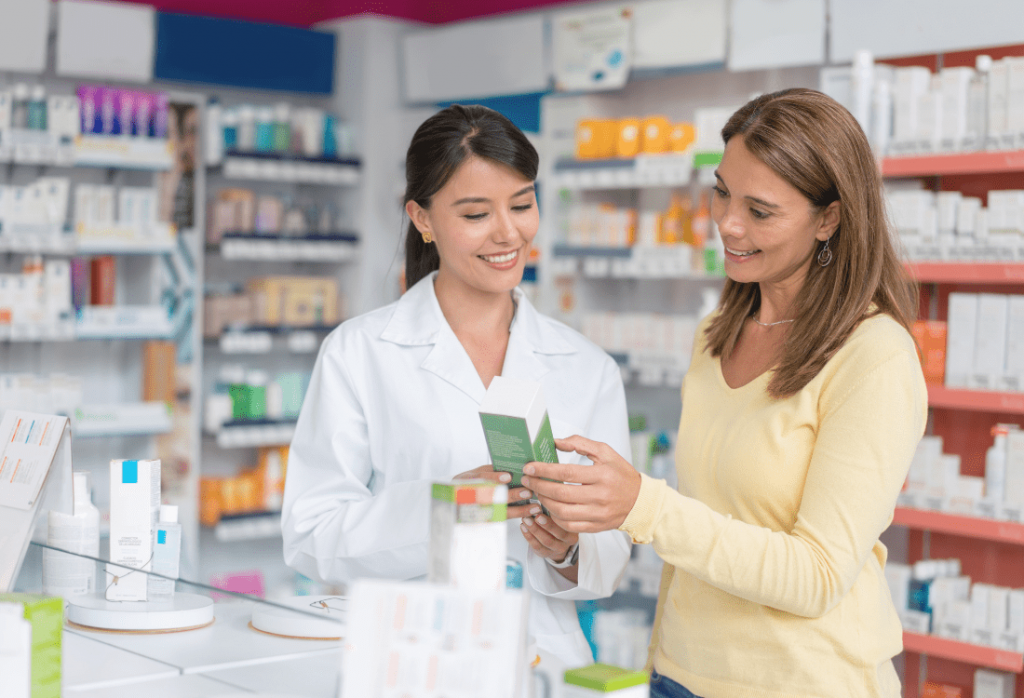A woman talking to a pharmacist about buying the best pregnancy test kit to suit her needs.
